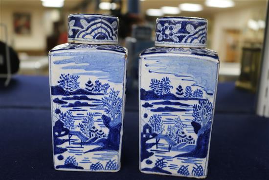 A pair of Dutch delft blue and white lidded tea caddies